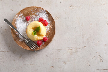 Tasty vanilla fondant with white chocolate and raspberries on light grey table, top view. Space for...
