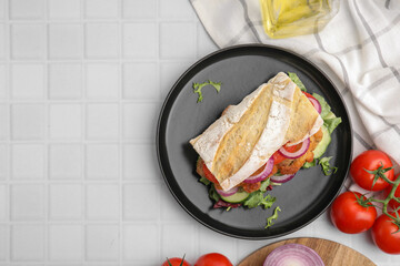 Delicious sandwich with schnitzel on white tiled table, flat lay. Space for text