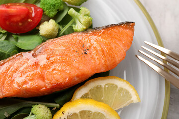 Healthy meal. Piece of grilled salmon, vegetables, lemon and spinach on table, top view