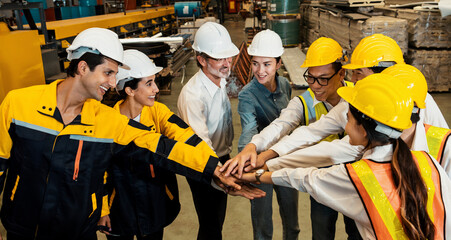 Cohesive and race diversity group of factory worker joining hands together in heavy steel industry factory exemplifying teamwork on diverse industrial engineering profession with team building concept - obrazy, fototapety, plakaty