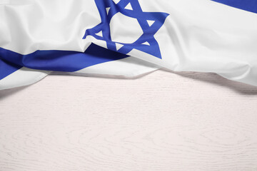 Flag of Israel on white wooden background, above view and space for text. National symbol