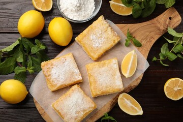 Tasty lemon bars with powdered sugar and mint on wooden table, flat lay - obrazy, fototapety, plakaty