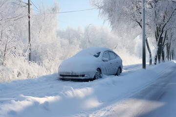 a snow-covered car covered with snow stands on the road after a snowfall.snow-covered roads