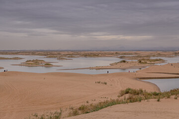 Fototapeta na wymiar The river going through the desert in Wuhai, Inner Mongolia, China