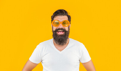 portrait photo of millennial stylish man in sunglasses. millennial stylish man isolated on yellow.