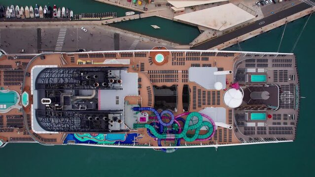 Overhead Aerial of Swimming Pool Slides and Sunbeds on Big Luxury Cruise Ship
