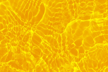 Defocus blurred transparent yellow colored clear calm water surface texture with splashes...