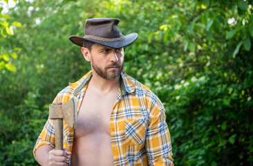 photo of man with hatchet, banner. man with hatchet. man with hatchet wearing checkered shirt.