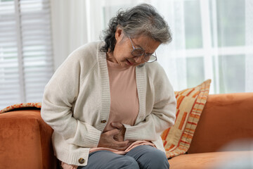 Asian Elderly senior woman stomach ache so pain illness,food poisoning in patient have a bacteria...