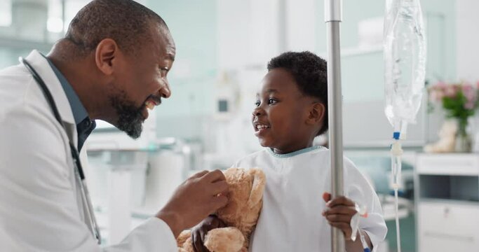 Pediatrician, happy and doctor playing with child as care, support and kindness in healthcare in a hospital or clinic. Iv drip, teddy bear and African professional with medical compassion for kid