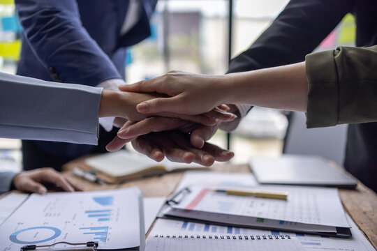 Business team standing hands together, Volunteer charity work. People join for cooperation success business. Panoramic teamwork business joins hand together concept,	