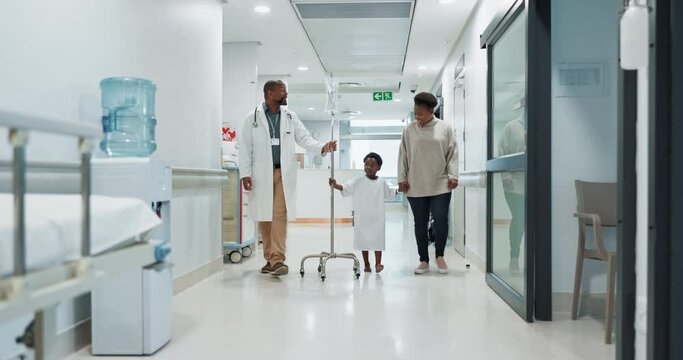 Medical, pediatrician and a doctor walking with a black family in a hospital corridor for diagnosis. Healthcare, communication and consulting with a medicine professional talking to a boy patient