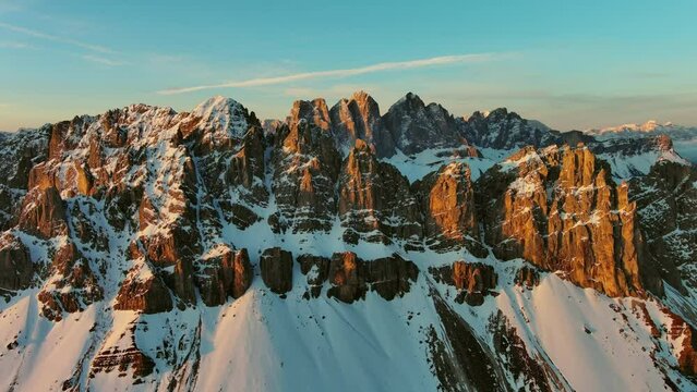 Aerial view of amazing rocky mountains in snow at sunrise, Dolomites, Italy, 4k