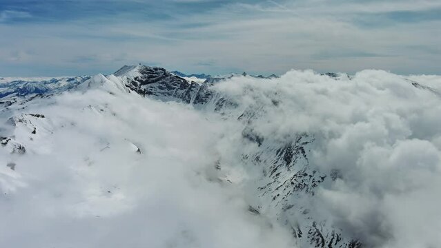 Aerial view of snow mountain range landscape with moving clouds. Alps mountains, Austria, 4k