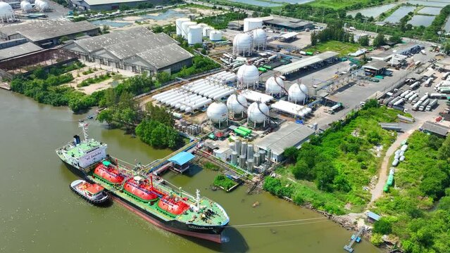 An aerial dance of pipes and tanks at a natural gas terminal, seen through the lens of a drone, where energy flows silently but powerfully beneath the surface. Aerial view drone.
