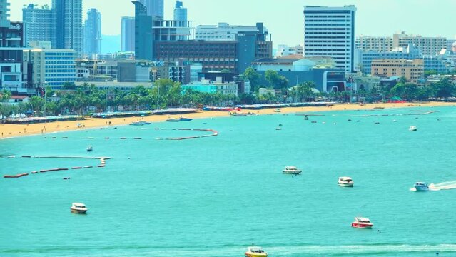 The drone's aerial perspective unveils Pattaya Beach as a lush, palm-fringed paradise where the turquoise sea kisses the golden sands. Renowned tropical paradise: A global ocean gem. Thailand. 4K HDR.