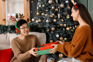 Young friends with Christmas gift at party