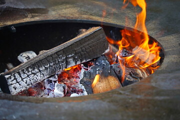 Burning logs in a cauldron in the open air