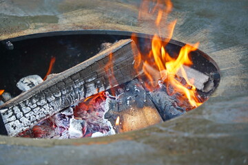 Burning logs in a cauldron in the open air