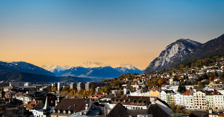 Fototapeta na wymiar The cityscape view in Innsbruck as city center town with beautiful houses, river Inn and Tyrol Alps, Austria