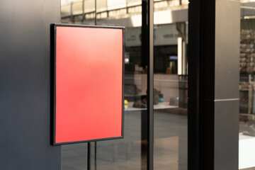 Red blank sign outside store for text or advertisement. Red square signboard of a modern shopping mall, mock up.