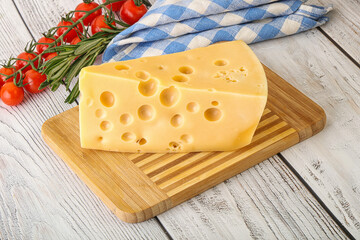 Maasdam cheese piece over board