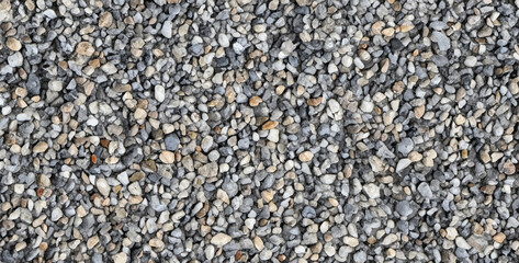 the gritty and uneven texture of walking barefoot on a gravel path.