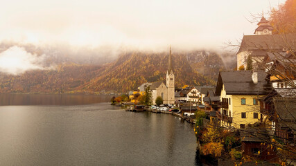 Landmark of tourist view in Autumn trees leaf with mistryin the morning at  Hallstatt, Austria....