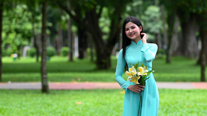 A young girl wearing a jade-green ao dai the traditional costume of Vietnam. Photo for tourism, culture, tradition, and the beauty of Asian people. Idea for train model in computer vision systems