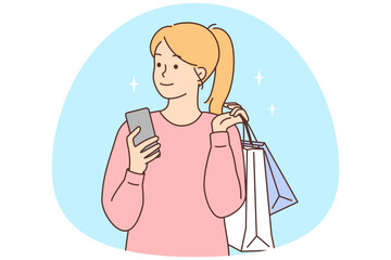 Happy woman with cellphone and shopping bags