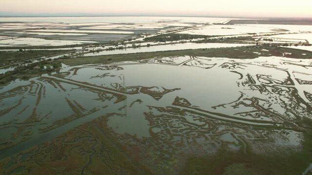 The Valli di Comacchio lagoon and wetland, drone push in tilt down view during day