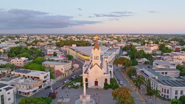 Aerial orbii9tng shot of famous Cathedral San Pedro Apostol during golden sunset in the evening - People on square and parking cars on road