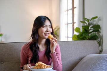 Woman spend time at home seated on sofa