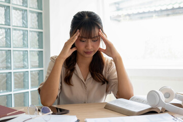 Young woman stressed while online study or project work.