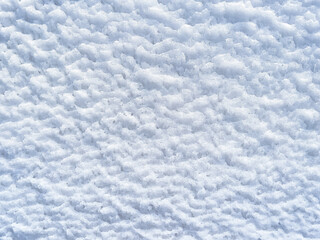 Fototapeta premium Winter background with snow patterns. Abstract background. The natural texture of snow. Icy surface. Clean, fresh snow. Ice pattern. Close-up. View from above. New Year's background. Copy space