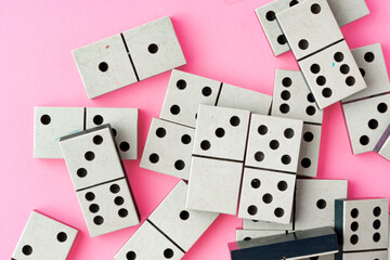 Domino tiles on pink background studio shot