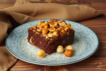 Brownie cake with chocolate and hazelnuts on plate