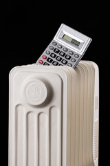 Conceptual plot about heating prices with calculator and electric radiator on black background