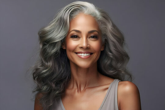 Older and mature black woman with smooth skin and beautiful long, grey, flowing hair. Beauty and cosmetics advertising concept image.