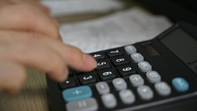 Man's hands using a calculator. Tax time.Tax concept. Close-up.
