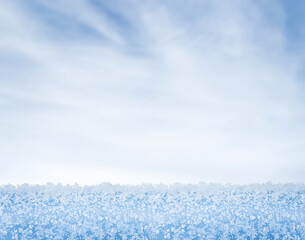 Winter background. Winter landscape. The backdrop. A snow-covered surface against a blue sky. Snowflakes. Nature. Snowfall. Outdoors. Copy space