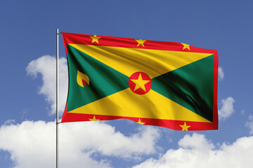 Grenada flag fluttering in the wind on sky.