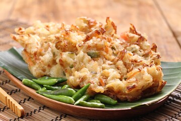 Bakwan sayur is Indonesian deep fried vegetable fritters. Found nation wide, mostly sold by street food vendors, the most popular version uses a mix of cabbage, carrot, and mung bean sprouts.