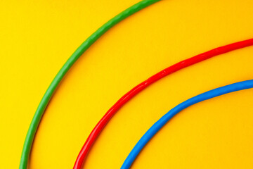Network cable on yellow background studio shot