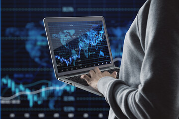 Laptop showing stock market analysis on screen