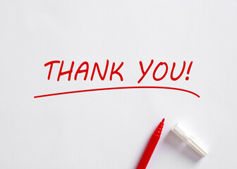 Hand written Thank You message with a red pen on white background. Gratitude concept.