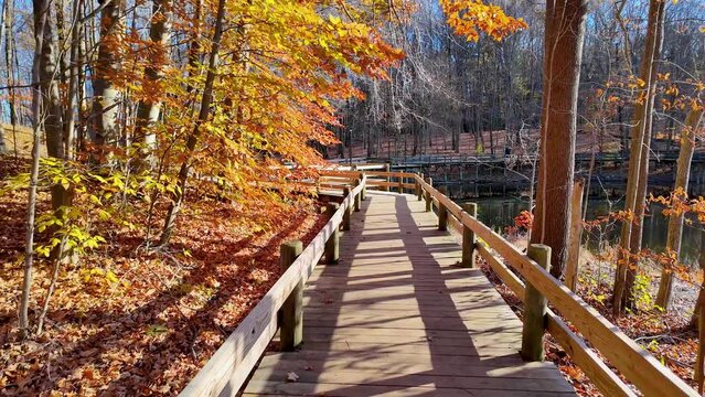 Scenic board walk trail in Maybery state park in Novi, Michigan during late autumn time.