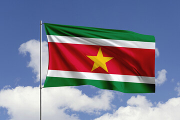 Suriname flag fluttering in the wind on sky.