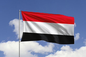 Yemen flag fluttering in the wind on sky.