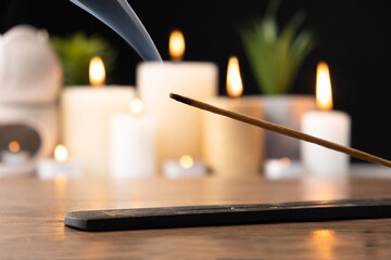 Incense stick on black and wooden background, incense smoke, for meditation and aromatherapy. - obrazy, fototapety, plakaty